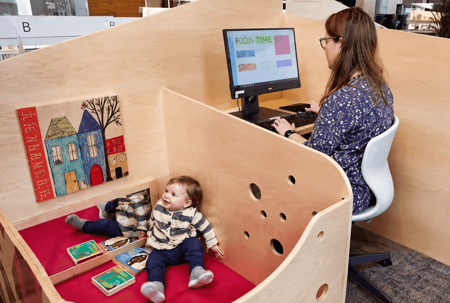 Baby in an office where adults are working